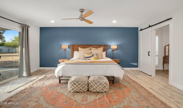 13620 N 80th Pl, Scottsdale, AZ 85260 - bedroom with a barn door, wood finished floors, baseboards, access to exterior, and recessed lighting