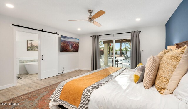 13620 N 80th Pl, Scottsdale, AZ 85260 - bedroom with access to outside, wood finished floors, a barn door, recessed lighting, and baseboards