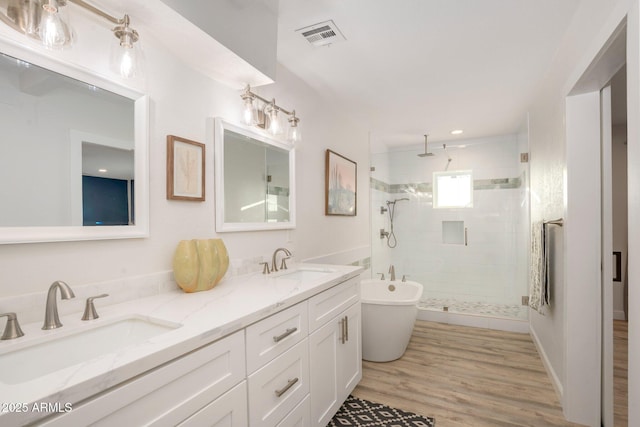 13620 N 80th Pl, Scottsdale, AZ 85260 - bathroom with a shower stall, double vanity, a soaking tub, and wood finished floors