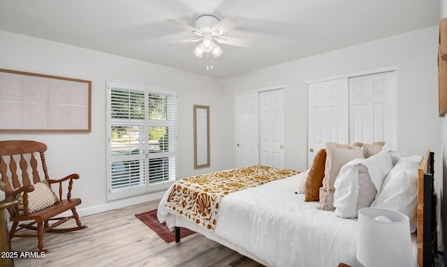 13620 N 80th Pl, Scottsdale, AZ 85260 - bedroom featuring two closets, light wood-style floors, baseboards, and ceiling fan