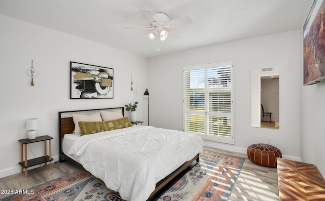 13620 N 80th Pl, Scottsdale, AZ 85260 - bedroom with wood finished floors, baseboards, and a ceiling fan