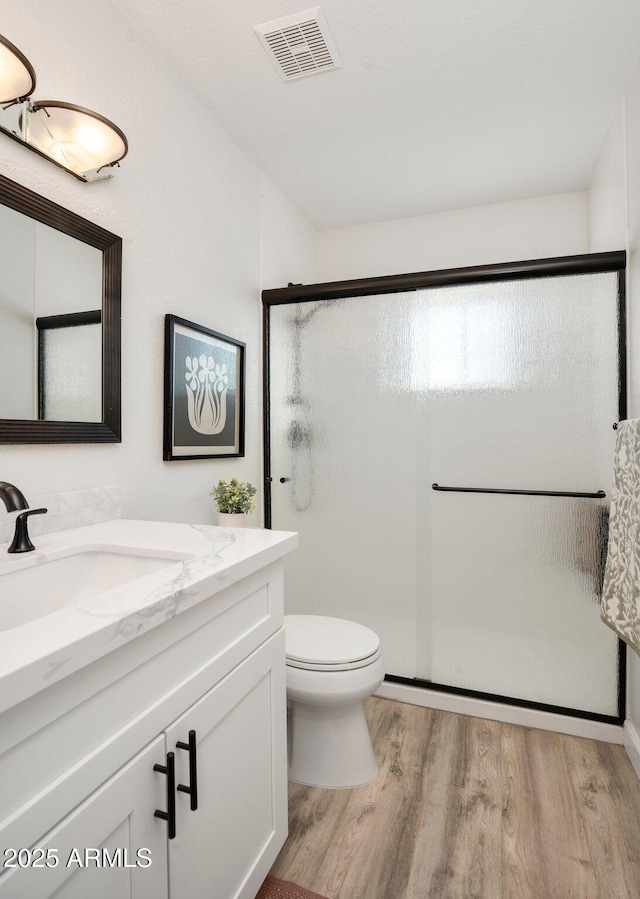 13620 N 80th Pl, Scottsdale, AZ 85260 - bathroom with wood finished floors, vanity, a shower stall, and toilet
