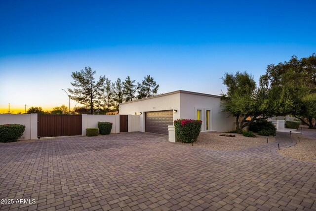 13620 N 80th Pl, Scottsdale, AZ 85260 - view of front facade with stucco siding, an attached garage, decorative driveway, and a gate