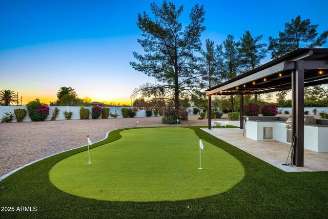 13620 N 80th Pl, Scottsdale, AZ 85260 - view of property's community with a fenced backyard, a patio, a putting area, area for grilling, and a water view