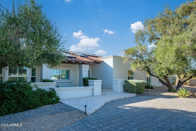 13620 N 80th Pl, Scottsdale, AZ 85260 - mediterranean / spanish-style house with stucco siding, roof mounted solar panels, and a tiled roof