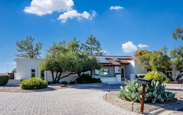 13620 N 80th Pl, Scottsdale, AZ 85260 - mediterranean / spanish-style house with stucco siding, a tile roof, roof mounted solar panels, and curved driveway