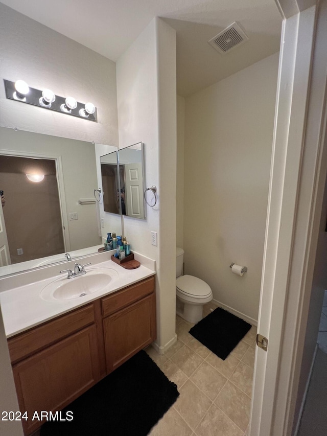 bathroom with tile patterned floors, vanity, and toilet