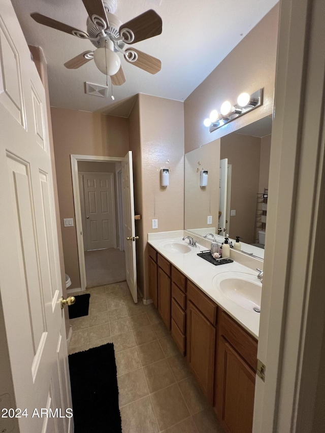 bathroom with tile patterned flooring, vanity, and ceiling fan