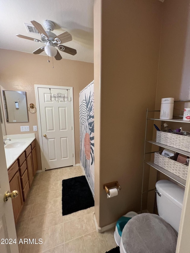 bathroom featuring tile patterned flooring, vanity, toilet, and ceiling fan