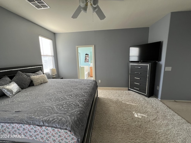 bedroom with carpet flooring, ensuite bath, and ceiling fan