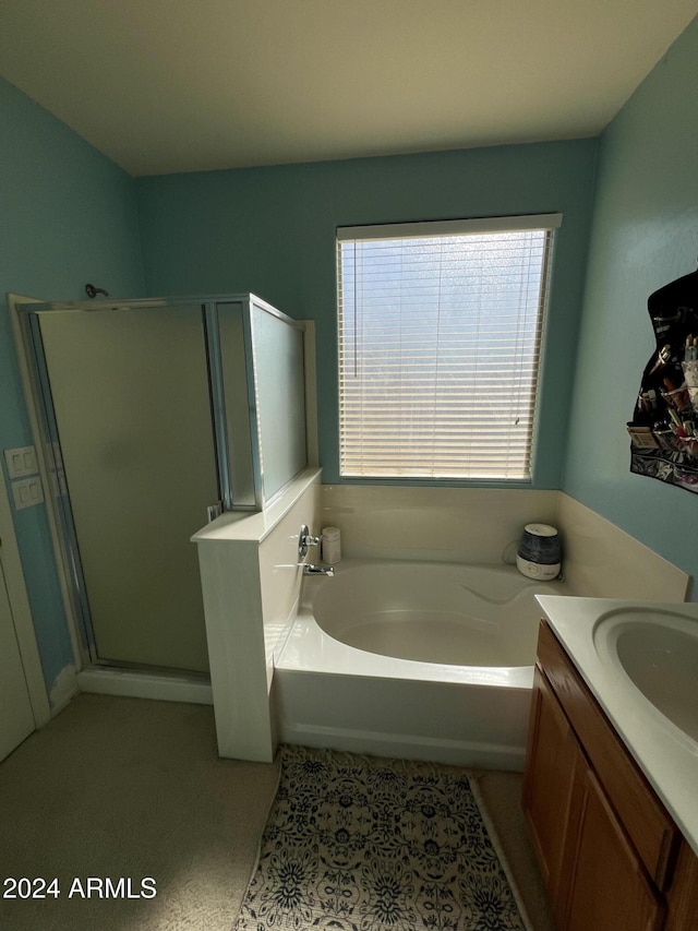 bathroom with separate shower and tub and vanity