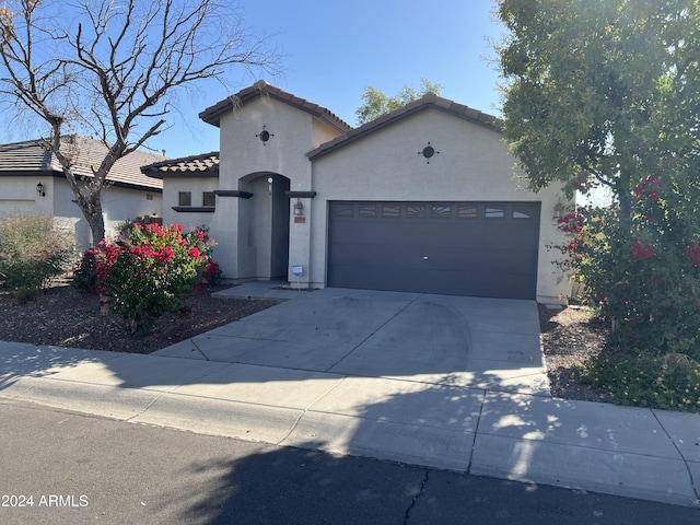 mediterranean / spanish-style house featuring a garage