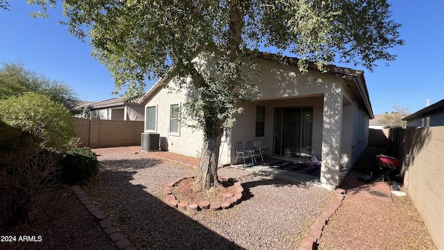 rear view of property featuring a patio area and central AC