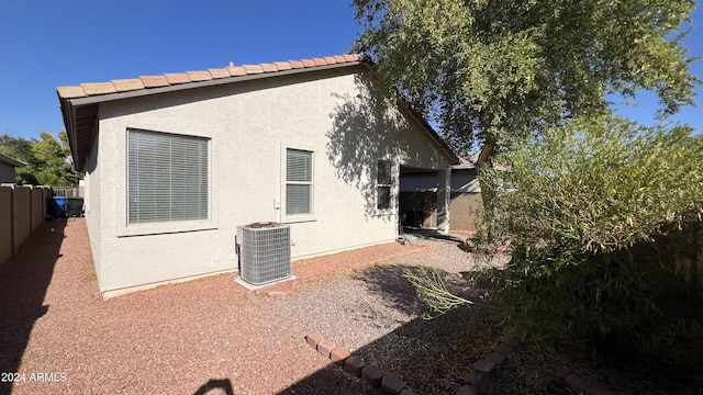 back of property featuring a patio area and cooling unit