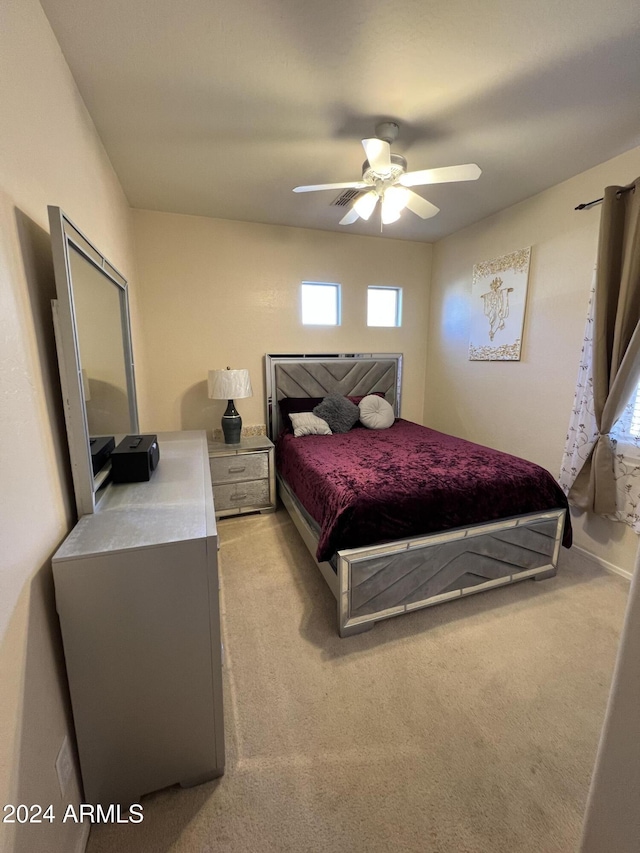 bedroom featuring light carpet and ceiling fan