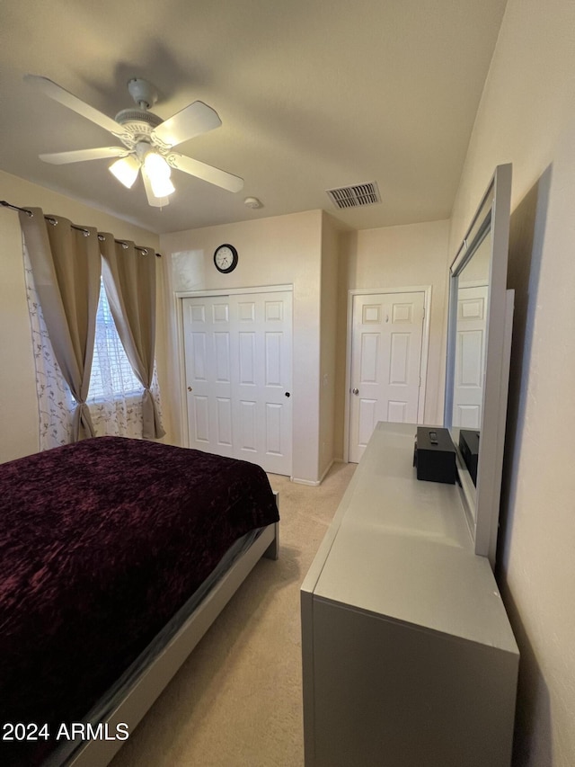 bedroom featuring ceiling fan and light colored carpet