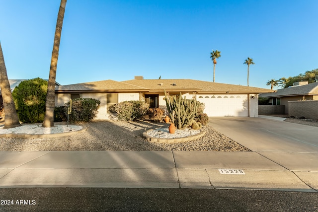 ranch-style home featuring a garage