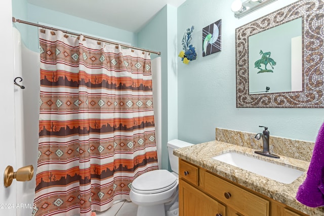 bathroom featuring tile patterned flooring, vanity, toilet, and a shower with shower curtain