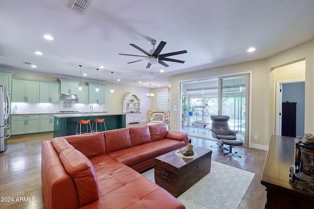 living room with light hardwood / wood-style floors and ceiling fan