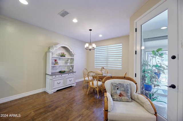 dining room featuring an inviting chandelier, dark wood-type flooring, and a wealth of natural light