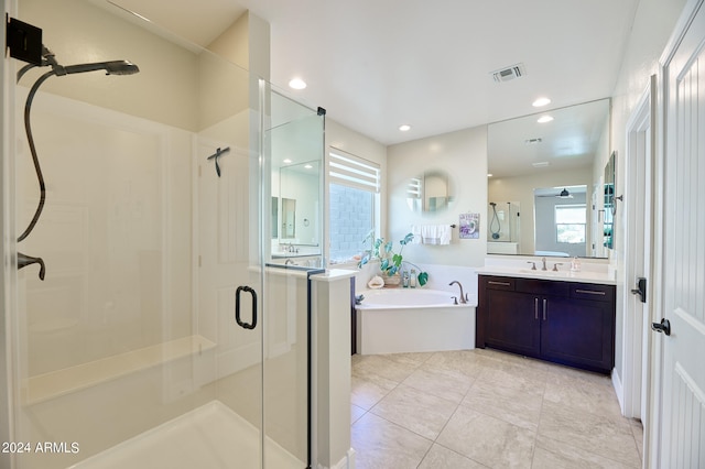 bathroom featuring vanity, tile patterned floors, and separate shower and tub