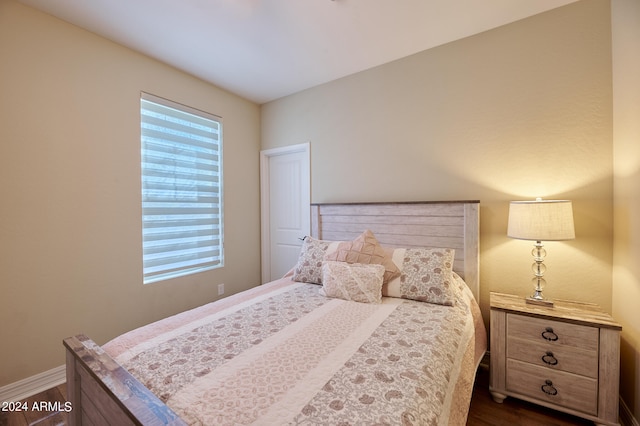 bedroom with dark hardwood / wood-style flooring