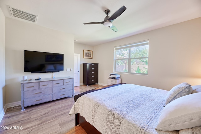 bedroom with light hardwood / wood-style floors and ceiling fan