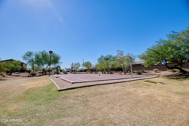 view of sport court featuring a lawn