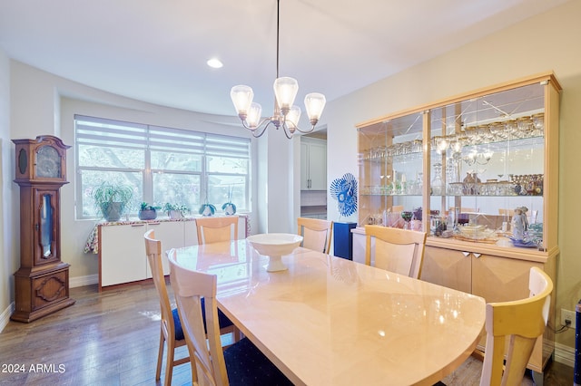 dining area with a chandelier and dark hardwood / wood-style flooring