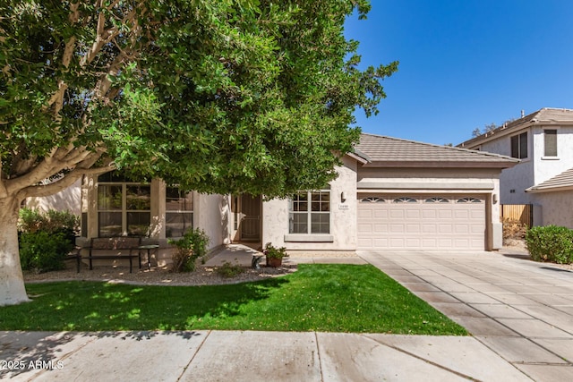 view of front of property with driveway, an attached garage, and stucco siding