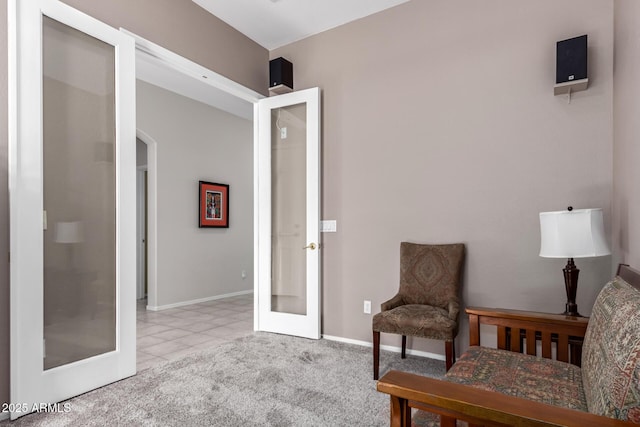 sitting room with carpet, baseboards, and french doors