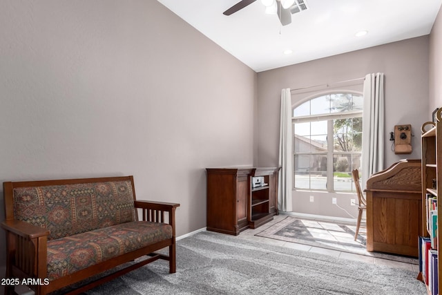 living area featuring visible vents, baseboards, ceiling fan, carpet, and vaulted ceiling