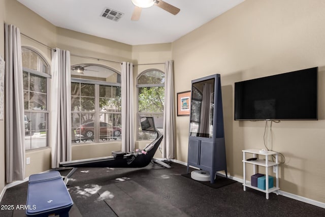 workout area featuring visible vents, ceiling fan, and baseboards
