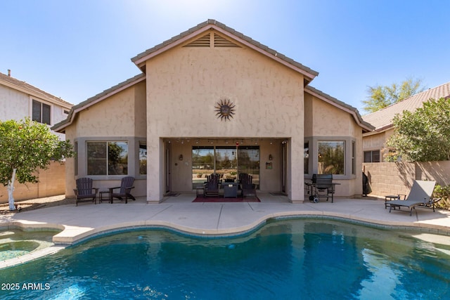 back of house featuring a patio, fence, and stucco siding