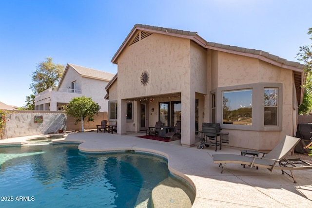 exterior space with fence, a fenced in pool, and a patio