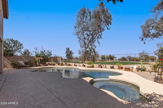 view of swimming pool with a patio, a fenced backyard, and a pool with connected hot tub