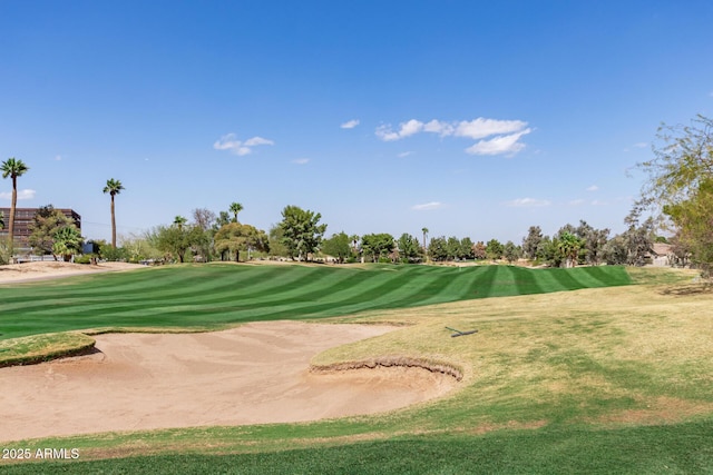 view of home's community featuring a lawn and golf course view