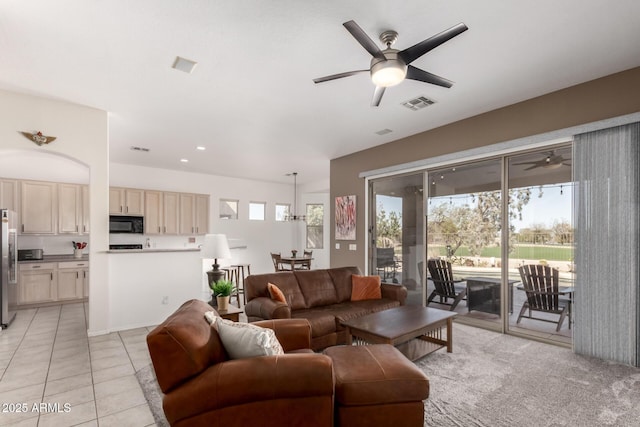 living room featuring ceiling fan, light tile patterned floors, visible vents, and a healthy amount of sunlight