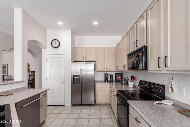kitchen featuring recessed lighting, light countertops, black appliances, and light tile patterned floors