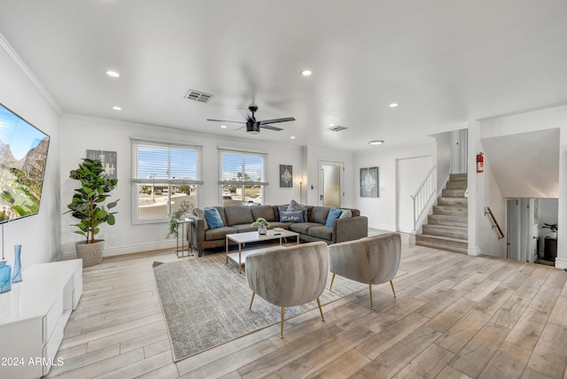 living room with light hardwood / wood-style flooring, ceiling fan, and ornamental molding