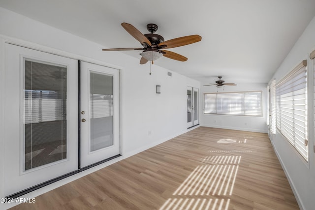 unfurnished sunroom with french doors and ceiling fan