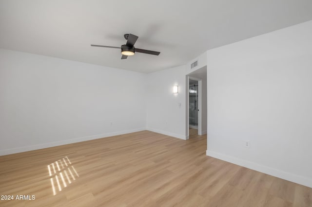 spare room with light hardwood / wood-style floors and ceiling fan