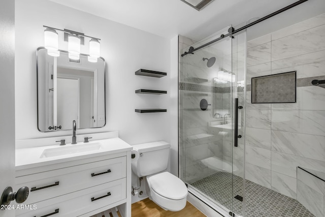 bathroom with hardwood / wood-style floors, vanity, toilet, and an enclosed shower