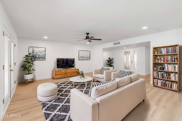 living room with light hardwood / wood-style floors and ceiling fan