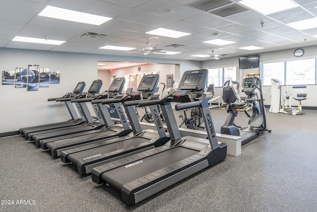 workout area with ceiling fan and a drop ceiling