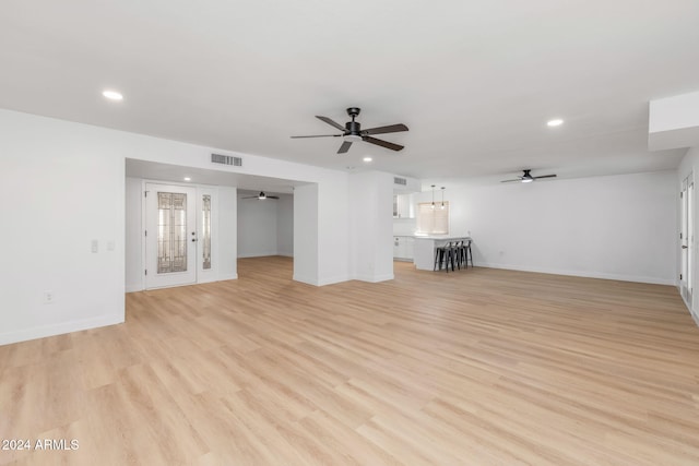 unfurnished living room featuring light hardwood / wood-style floors and ceiling fan