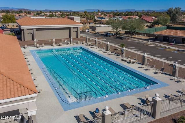 view of swimming pool with a mountain view and a patio