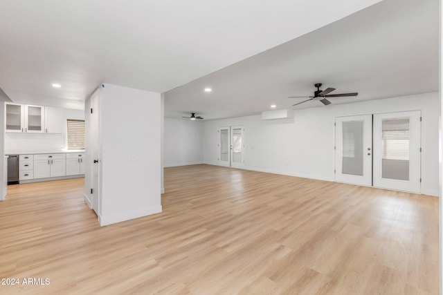 unfurnished living room with french doors and light hardwood / wood-style flooring