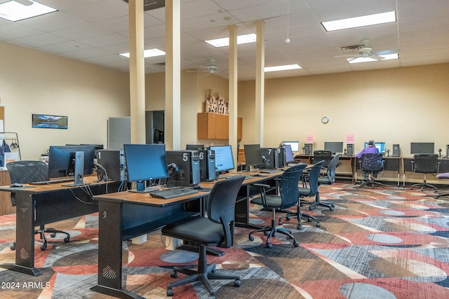 carpeted office featuring a drop ceiling and ceiling fan