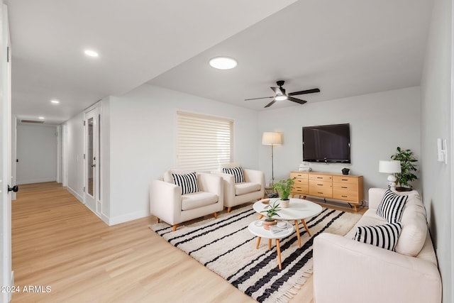 living room featuring ceiling fan and wood-type flooring